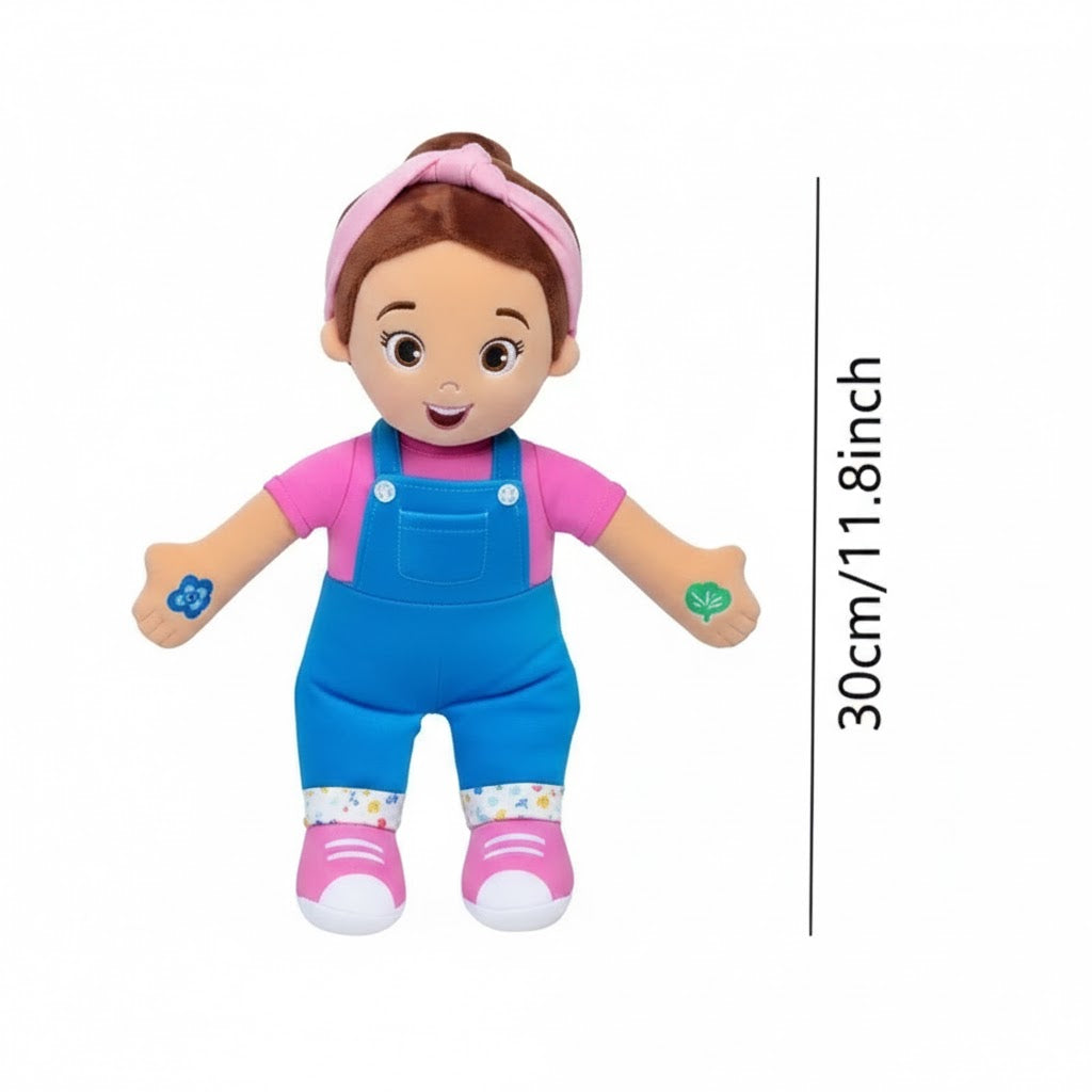 Doll with pink shirt and blue overalls, standing on a white background with a measurement label.